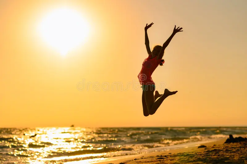 Happy Girl Jumping Beach Against Background Sea Sunset Raising Her Hands Up 195777673