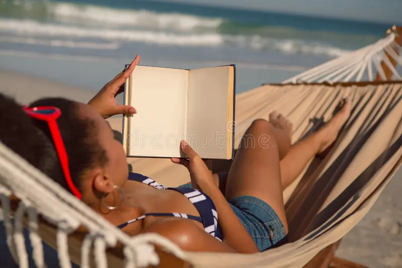 Woman Reading Book Relaxing Hammock Beach Rear View African American Sunshine 150366277